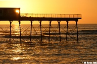 Sunset through the pier.